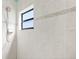 Shower with tiled walls and small window at 7925 Royal Queensland Way, Lakewood Ranch, FL 34202