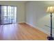 Bright bedroom with hardwood floors and access to a balcony at 1001 Tartan Dr # 207, Palm Harbor, FL 34684