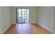 Bedroom with hardwood floors and sliding glass doors to a balcony at 1001 Tartan Dr # 207, Palm Harbor, FL 34684