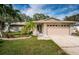 Charming single-story home with lush landscaping and a well-manicured lawn at 2342 Hazelwood Ln, Clearwater, FL 33763