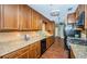 Kitchen with granite counters, wood cabinets, stainless steel appliances, and laminate flooring at 2342 Hazelwood Ln, Clearwater, FL 33763