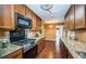 Well-lit kitchen features granite countertops, wooden cabinets, and modern stainless steel appliances at 2342 Hazelwood Ln, Clearwater, FL 33763