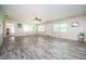 Bright living room with tile flooring, neutral walls, ceiling fan, and ample natural light at 2342 Hazelwood Ln, Clearwater, FL 33763