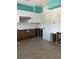 Kitchen with teal walls and water damage at 2716 Miriam S St, Gulfport, FL 33711