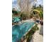 Relaxing kidney-shaped pool surrounded by lush tropical landscaping at 2716 Miriam S St, Gulfport, FL 33711