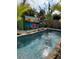 Tropical-themed pool with painted shed in the background at 2716 Miriam S St, Gulfport, FL 33711