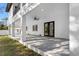 Covered back patio with gray concrete flooring and modern lighting at 7306 Exter Way, Tampa, FL 33615