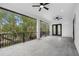 Covered back porch overlooking a lush green backyard with trees at 7306 Exter Way, Tampa, FL 33615