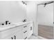 Modern bathroom with white vanity, marble countertops, and black fixtures at 7306 Exter Way, Tampa, FL 33615