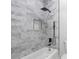 Bathroom with marble tile shower and modern black fixtures at 7306 Exter Way, Tampa, FL 33615