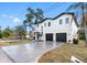 Modern two-story home with three-car garage and driveway at 7306 Exter Way, Tampa, FL 33615