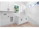 Laundry room with white cabinets and countertop at 7306 Exter Way, Tampa, FL 33615