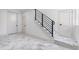 Modern staircase with metal railing and marble flooring at 7306 Exter Way, Tampa, FL 33615