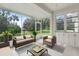 Relaxing screened porch overlooking a lush green view at 819 Tremont Greens Ln, Sun City Center, FL 33573