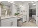 Well-lit bathroom with double sink vanity, granite countertops, and a walk-in closet at 10111 Craftsman Park Way, Palmetto, FL 34221