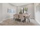 Elegant dining room with a modern table set, neutral color palette, and natural light at 10111 Craftsman Park Way, Palmetto, FL 34221