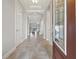 View of the foyer showcasing tray ceilings, arched entryways, and a view through to the living area at 10111 Craftsman Park Way, Palmetto, FL 34221