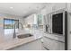 Bright kitchen featuring stainless steel refrigerator, white cabinetry, and backyard views at 10111 Craftsman Park Way, Palmetto, FL 34221