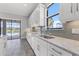 Well-lit kitchen showcasing granite countertops, stainless steel appliances, and an adjacent outdoor view at 10111 Craftsman Park Way, Palmetto, FL 34221