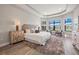 Serene main bedroom featuring tray ceiling, large windows, and plush carpeting at 10111 Craftsman Park Way, Palmetto, FL 34221