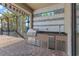 Up close picture of the outdoor kitchen, featuring a stainless steel grill, sink, and countertop space at 10111 Craftsman Park Way, Palmetto, FL 34221