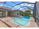 Screened-in pool area with brick-paved deck and lush landscaping at 10111 Craftsman Park Way, Palmetto, FL 34221