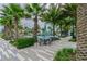 Seating area with tables and umbrellas near the pool at 14929 Promenade Pkwy, Odessa, FL 33556