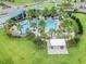 Resort-style pool with multiple lounging areas and palm trees at 14929 Promenade Pkwy, Odessa, FL 33556