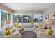 Bright sitting area with water views and yellow accent pillows at 17710 Long Point Dr, Redington Shores, FL 33708