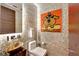 Small modern powder room with mosaic tile and playful art at 226 5Th N Ave # 1406, St Petersburg, FL 33701