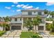 Two-story house with a modern design, metal roof, and a large driveway at 7949 2Nd S Ave, St Petersburg, FL 33707