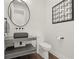 Stylish powder room with floating vanity and dark accents at 7949 2Nd S Ave, St Petersburg, FL 33707