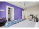 Serene bedroom with a purple accent wall and built-in closet at 7949 2Nd S Ave, St Petersburg, FL 33707