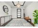 Bright and spacious entryway with modern console table and statement rug at 7949 2Nd S Ave, St Petersburg, FL 33707