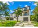 Two-story modern home with two-car garage and tropical landscaping at 7949 2Nd S Ave, St Petersburg, FL 33707