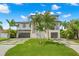 Two-story modern home with a two-car garage and tropical landscaping at 7949 2Nd S Ave, St Petersburg, FL 33707