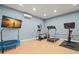 Well-equipped home gym featuring cardio and strength training machines at 7949 2Nd S Ave, St Petersburg, FL 33707