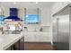 White kitchen cabinets, stainless steel appliances and granite countertops at 7949 2Nd S Ave, St Petersburg, FL 33707