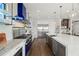 Modern kitchen with stainless steel appliances and a blue range hood at 7949 2Nd S Ave, St Petersburg, FL 33707