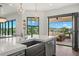 Modern kitchen with a large island, sink, and views of the patio and waterfront at 7949 2Nd S Ave, St Petersburg, FL 33707