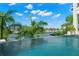 Inviting pool area overlooking the waterfront with lush tropical landscaping at 7949 2Nd S Ave, St Petersburg, FL 33707