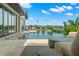 Luxury pool and patio area with water view and seating area at 7949 2Nd S Ave, St Petersburg, FL 33707