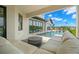 Modern pool with stone steps leading into the water and covered patio at 7949 2Nd S Ave, St Petersburg, FL 33707