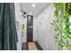 Stylish bathroom with a dual shower head and modern tile, complemented by a hanging plant at 1367 51St Ne Ave, St Petersburg, FL 33703