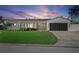 The home’s exterior showcases a newly landscaped yard, grey roof and blue skies at sunset at 1367 51St Ne Ave, St Petersburg, FL 33703