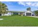 Well-manicured front yard featuring fresh green lawn and lush landscaping framing the house at 1367 51St Ne Ave, St Petersburg, FL 33703