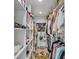 Well-organized walk-in closet with custom shelving and storage solutions for clothing and accessories at 1367 51St Ne Ave, St Petersburg, FL 33703