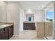 Elegant bathroom with double sinks, granite countertop, and a walk-in shower at 8277 Bower Bass Cir, Wesley Chapel, FL 33545