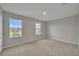 Spacious bedroom with neutral walls and carpet, featuring two windows with natural light at 8277 Bower Bass Cir, Wesley Chapel, FL 33545