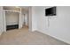 Bedroom with wall-mounted TV, closet, and loft storage at 8277 Bower Bass Cir, Wesley Chapel, FL 33545